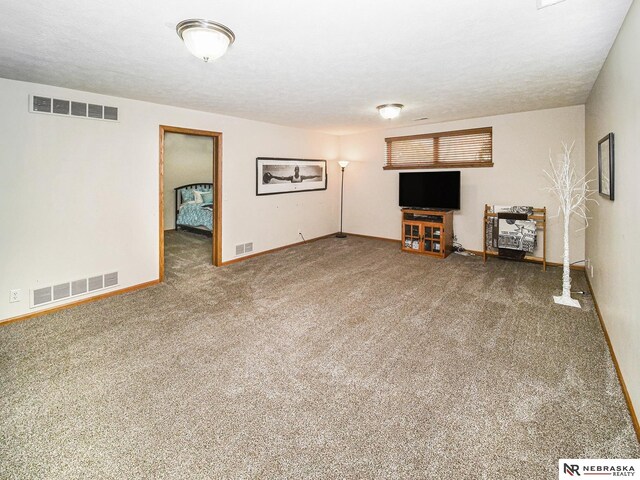unfurnished living room featuring carpet flooring and baseboards