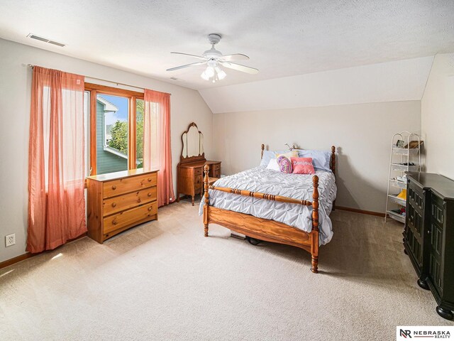 bedroom with light carpet, lofted ceiling, baseboards, and a ceiling fan