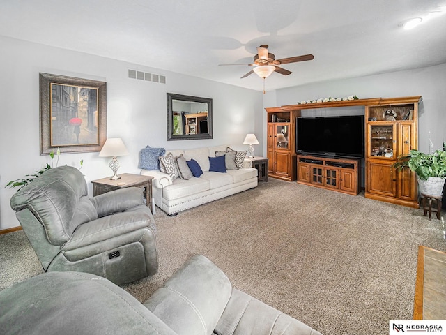 living room featuring ceiling fan and carpet