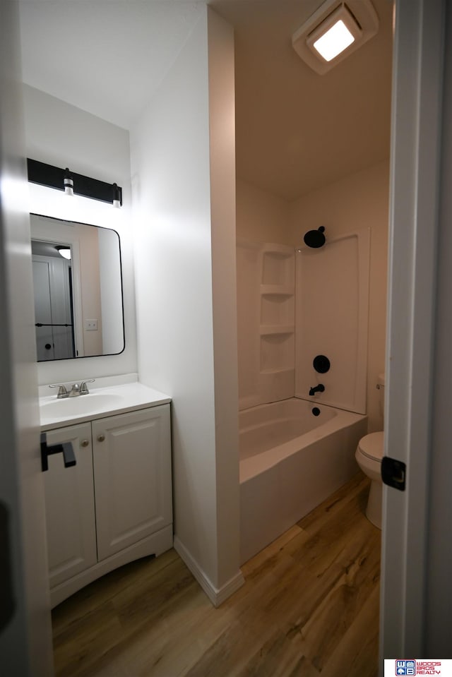 4915 Walker Ave, Lincoln, NE 68504 - full bathroom featuring wood finished floors, vanity, toilet, and shower / washtub combination