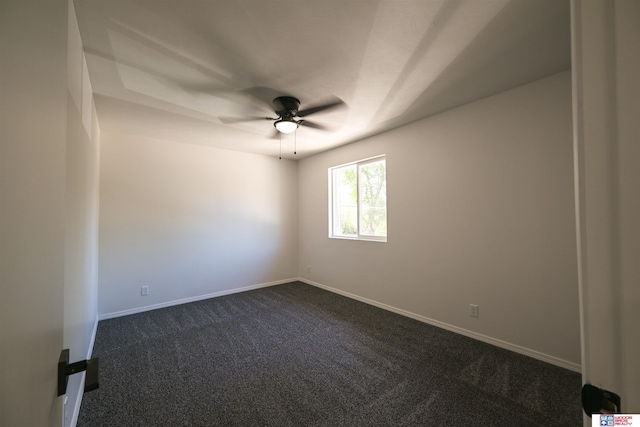 4915 Walker Ave, Lincoln, NE 68504 - empty room with dark colored carpet, ceiling fan, and baseboards