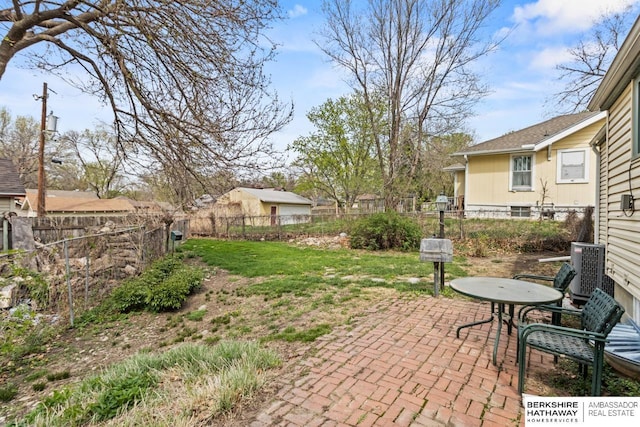 exterior space featuring central air condition unit, a patio area, and a fenced backyard