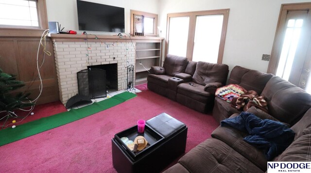 carpeted living area featuring a brick fireplace and a healthy amount of sunlight