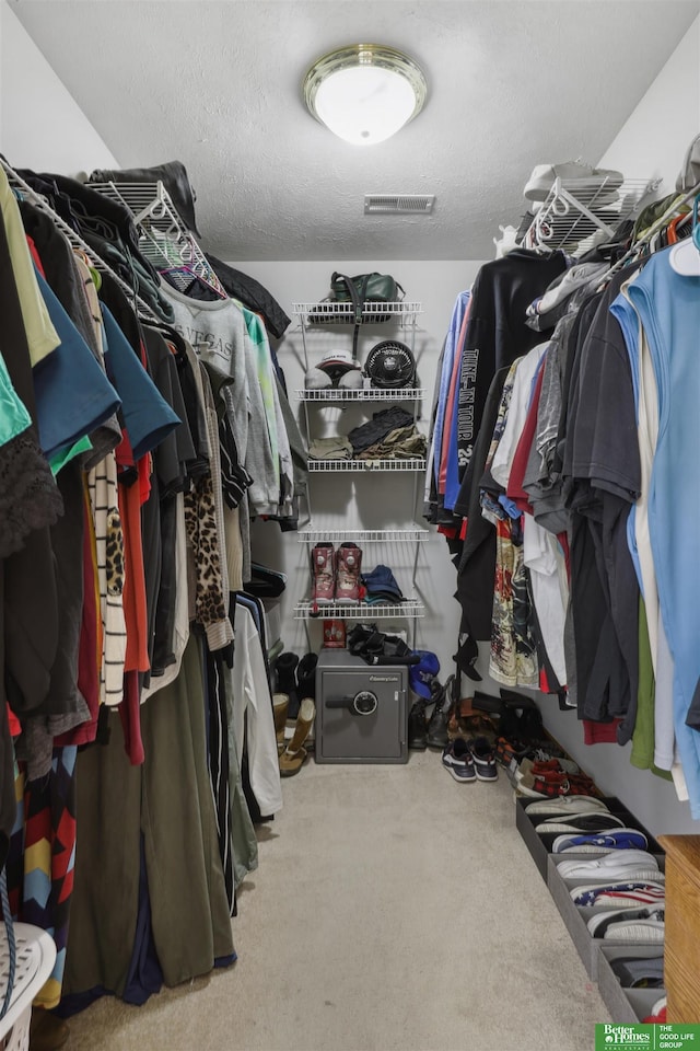 spacious closet featuring visible vents and carpet