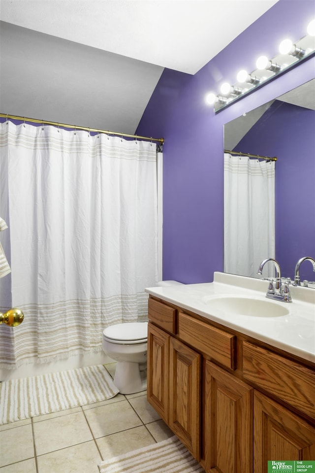 bathroom featuring curtained shower, tile patterned flooring, vanity, and toilet