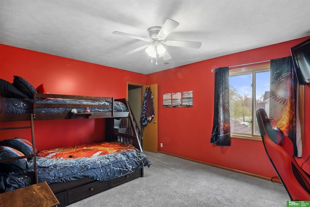 carpeted bedroom with baseboards and ceiling fan