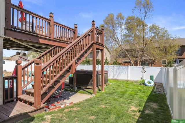 view of yard featuring a fenced backyard, a hot tub, and a deck