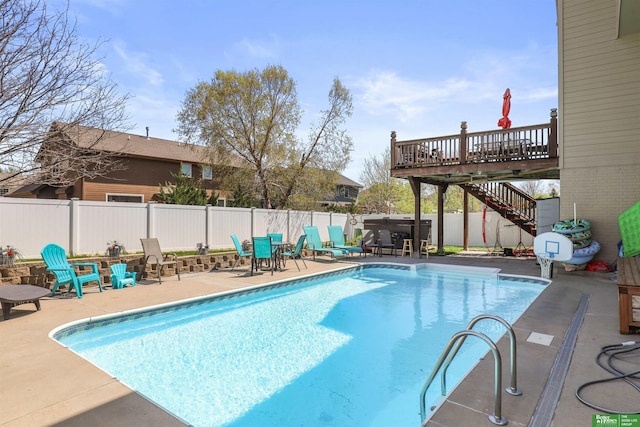 view of swimming pool with a patio area, a fenced in pool, and stairway
