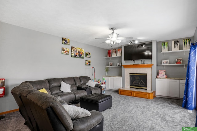 living area featuring a fireplace, carpet floors, and a ceiling fan