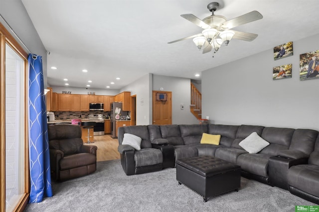 living room featuring recessed lighting, stairway, light carpet, and ceiling fan