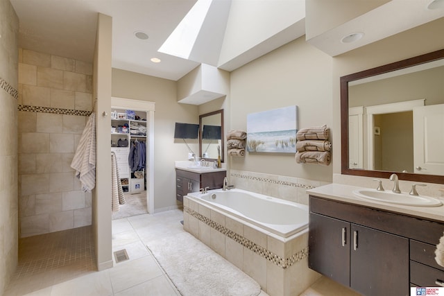 4510 W High Ridge Pl, Lincoln, NE 68522 - bathroom with a skylight, walk in shower, two vanities, a bath, and a sink