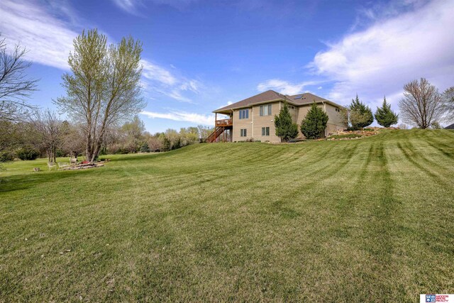 4510 W High Ridge Pl, Lincoln, NE 68522 - view of yard featuring a wooden deck and stairs