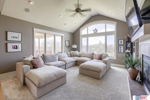 4510 W High Ridge Pl, Lincoln, NE 68522 - carpeted living area featuring lofted ceiling, a textured ceiling, ceiling fan, and baseboards