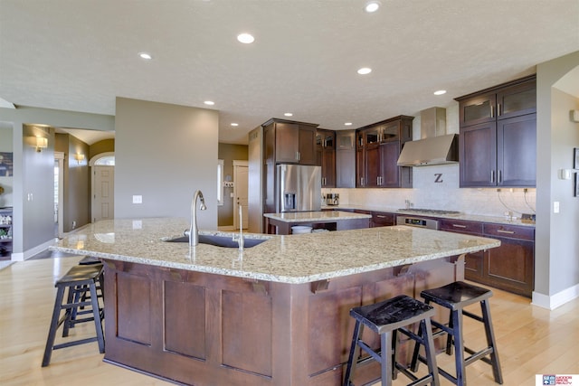 4510 W High Ridge Pl, Lincoln, NE 68522 - kitchen with recessed lighting, a spacious island, light wood-style floors, appliances with stainless steel finishes, and a sink