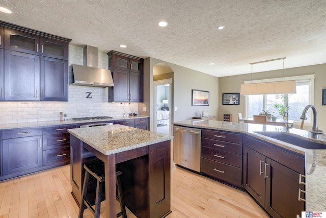 4510 W High Ridge Pl, Lincoln, NE 68522 - kitchen featuring stainless steel appliances, a textured ceiling, wall chimney range hood, and a sink