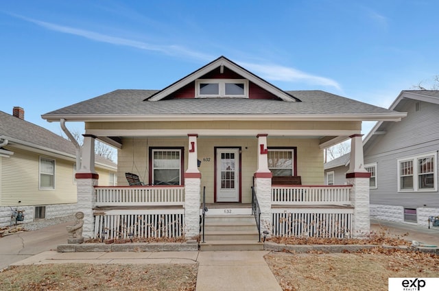 view of front of property with roof with shingles and a porch