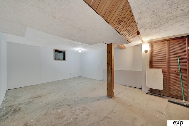 finished below grade area with a textured ceiling
