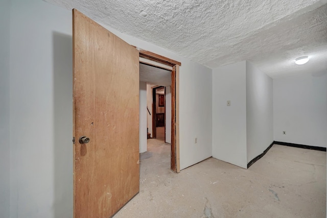 empty room with concrete flooring and a textured ceiling