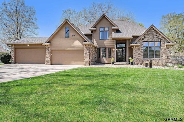 craftsman inspired home with roof with shingles, concrete driveway, an attached garage, brick siding, and a front yard