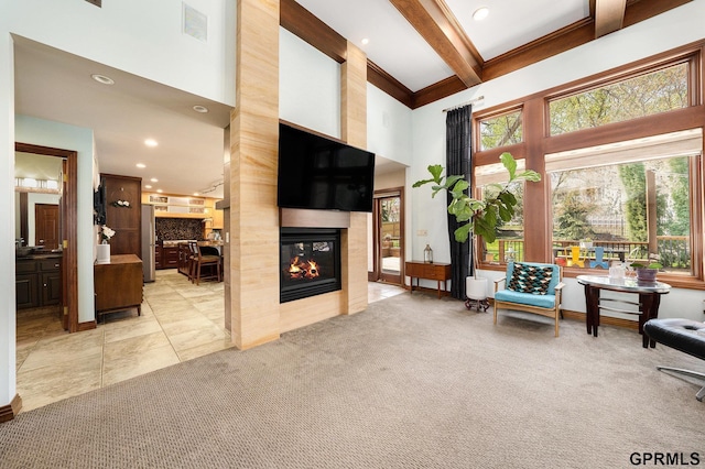 living area with beam ceiling, visible vents, carpet, recessed lighting, and a multi sided fireplace