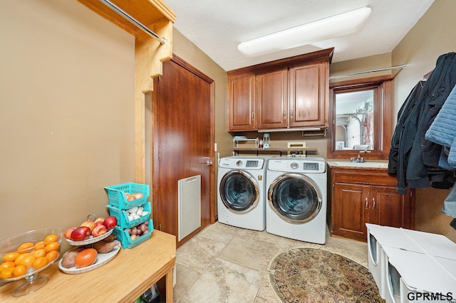 clothes washing area with cabinet space and independent washer and dryer
