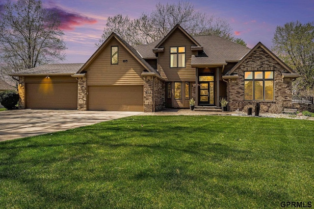 craftsman house featuring an attached garage, driveway, and a yard