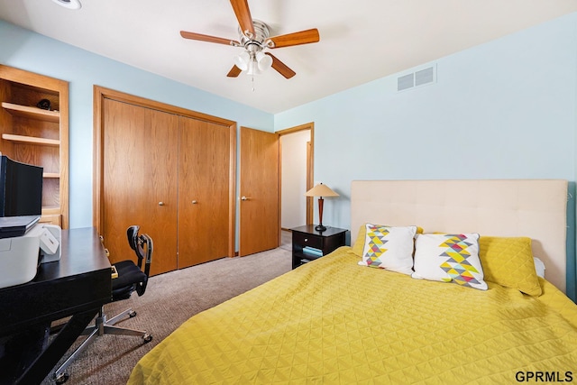 carpeted bedroom featuring a closet, visible vents, and a ceiling fan