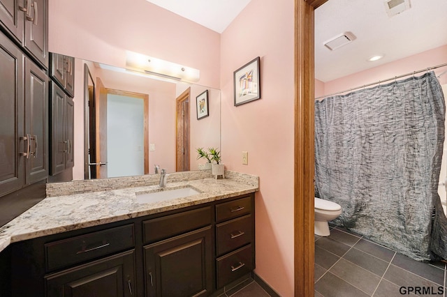 full bathroom with tile patterned flooring, toilet, vanity, and curtained shower