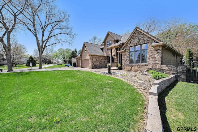 view of front of home with fence, a front lawn, concrete driveway, an attached garage, and brick siding