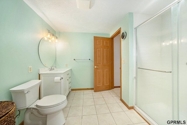 full bath featuring toilet, vanity, tile patterned floors, and a stall shower