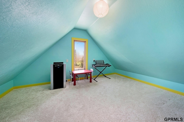 rec room featuring vaulted ceiling, carpet flooring, a textured ceiling, and baseboards