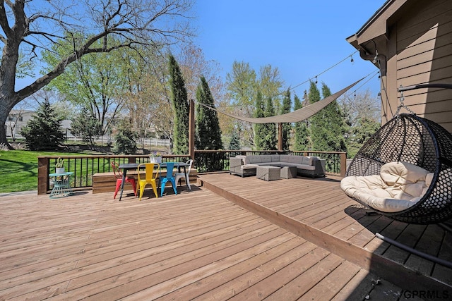deck with a yard, outdoor lounge area, and outdoor dining area