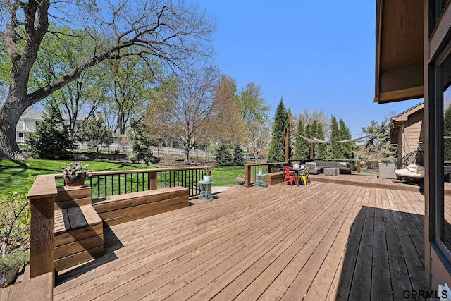 wooden deck with fence and a lawn