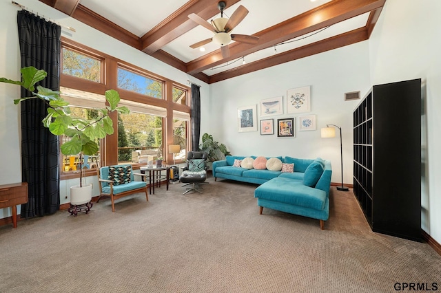 living room with carpet, a high ceiling, visible vents, a ceiling fan, and beam ceiling