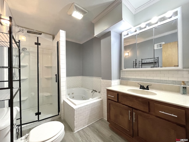 full bathroom featuring a shower stall, a tub with jets, wood finished floors, vanity, and ornamental molding