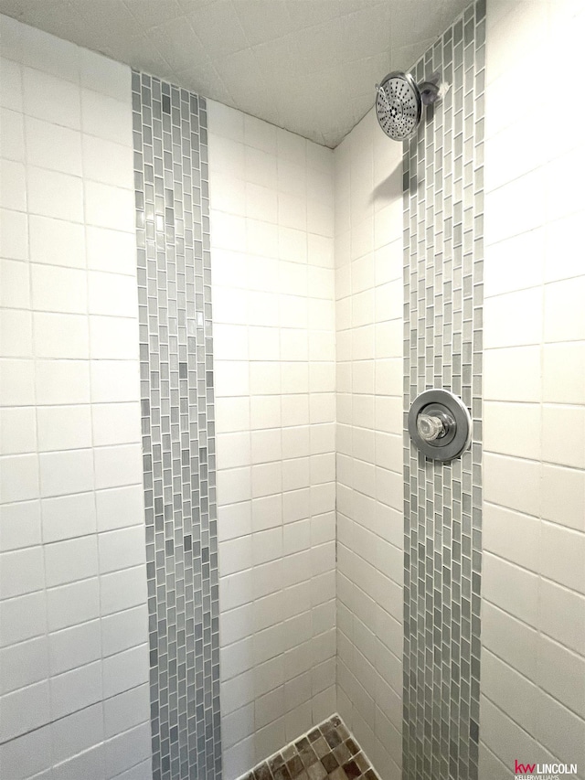 full bath with a tile shower