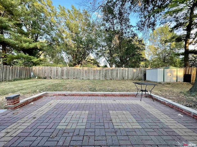 view of patio / terrace featuring an outbuilding, a shed, and a fenced backyard