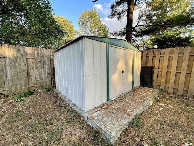 view of shed with a fenced backyard