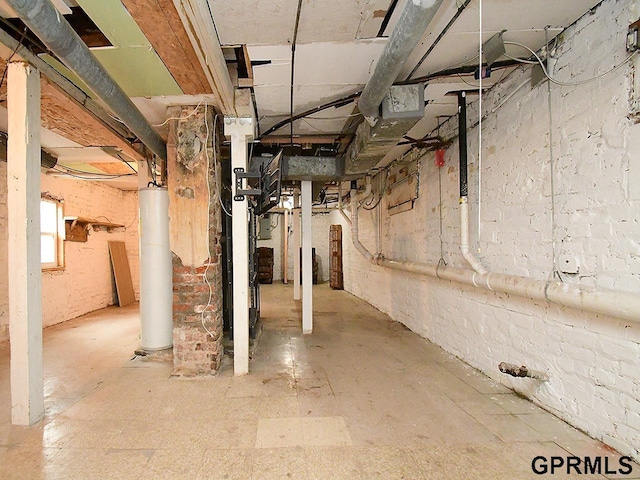 basement featuring gas water heater and heating unit