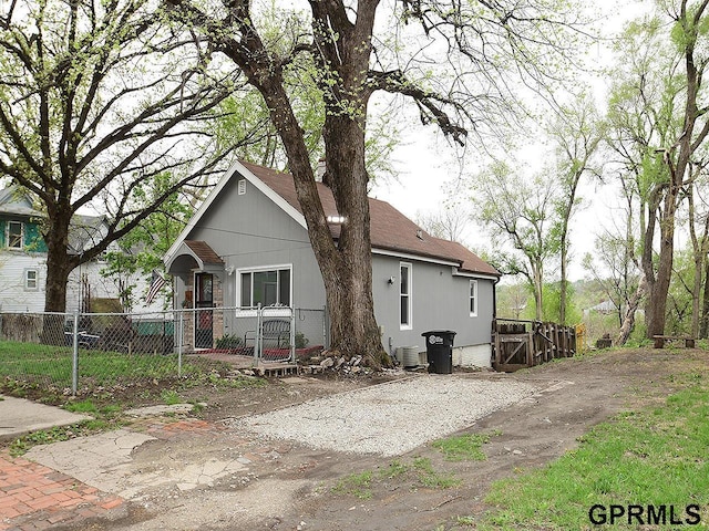 view of front of property with cooling unit and fence private yard