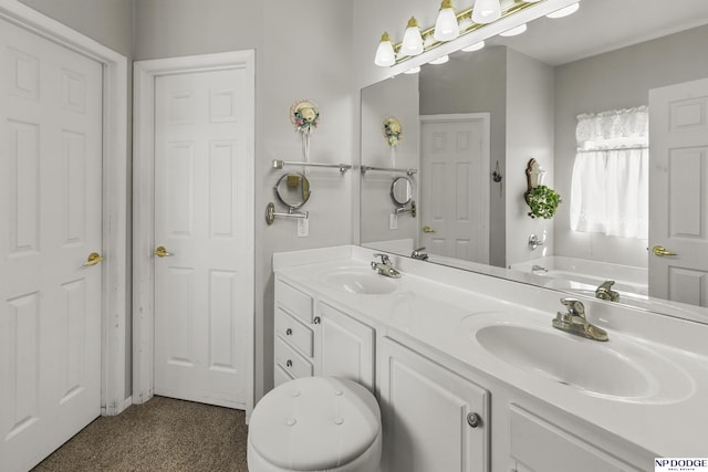 bathroom with a garden tub, double vanity, and a sink