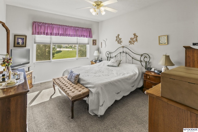 carpeted bedroom featuring ceiling fan and baseboards