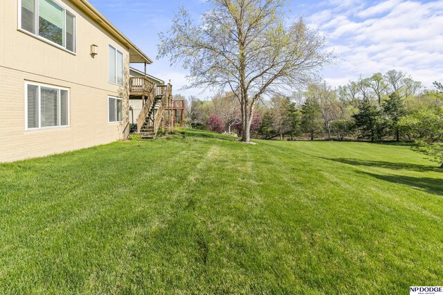 view of yard featuring a deck and stairway