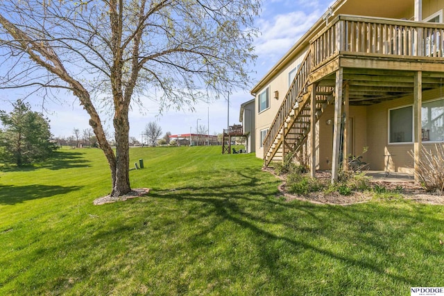 view of yard featuring a deck and stairs