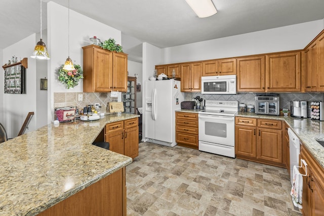 kitchen featuring tasteful backsplash, white appliances, light stone countertops, and brown cabinetry