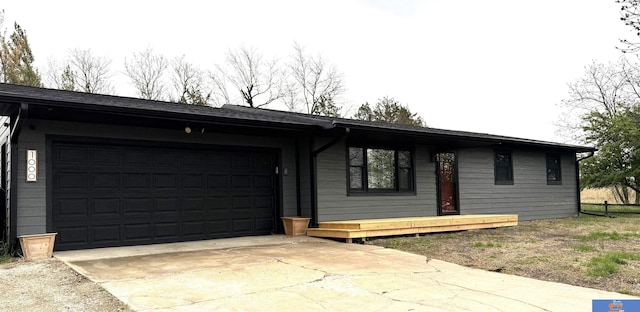 ranch-style home with a garage and driveway