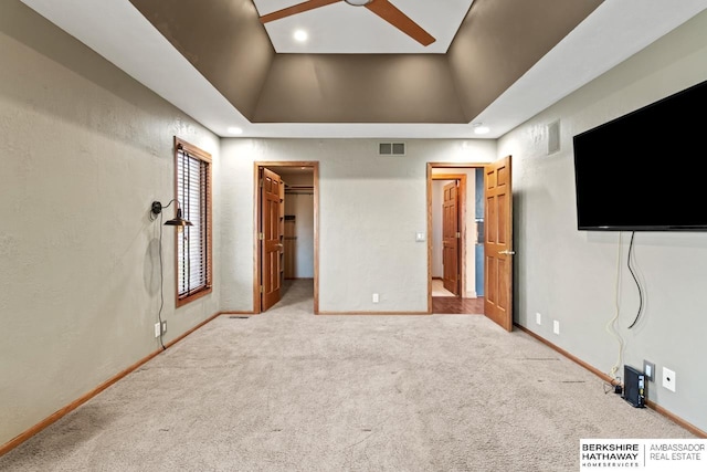 unfurnished bedroom with recessed lighting, a raised ceiling, visible vents, carpet, and baseboards