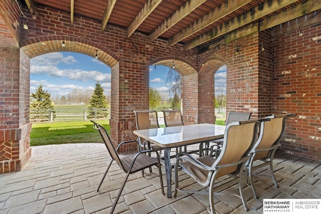 view of patio featuring fence and outdoor dining area