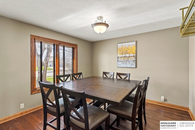 dining room with hardwood / wood-style floors and baseboards