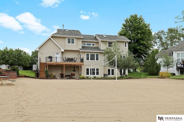 rear view of property featuring a deck